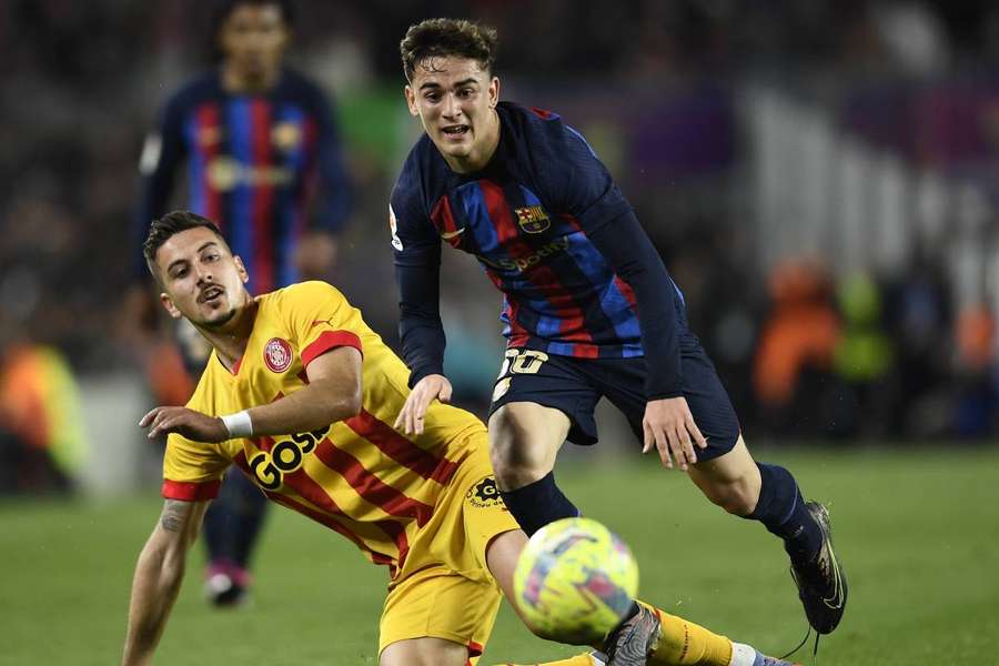 Barcelona's Gavi vies with Javier Hernandez of Girona