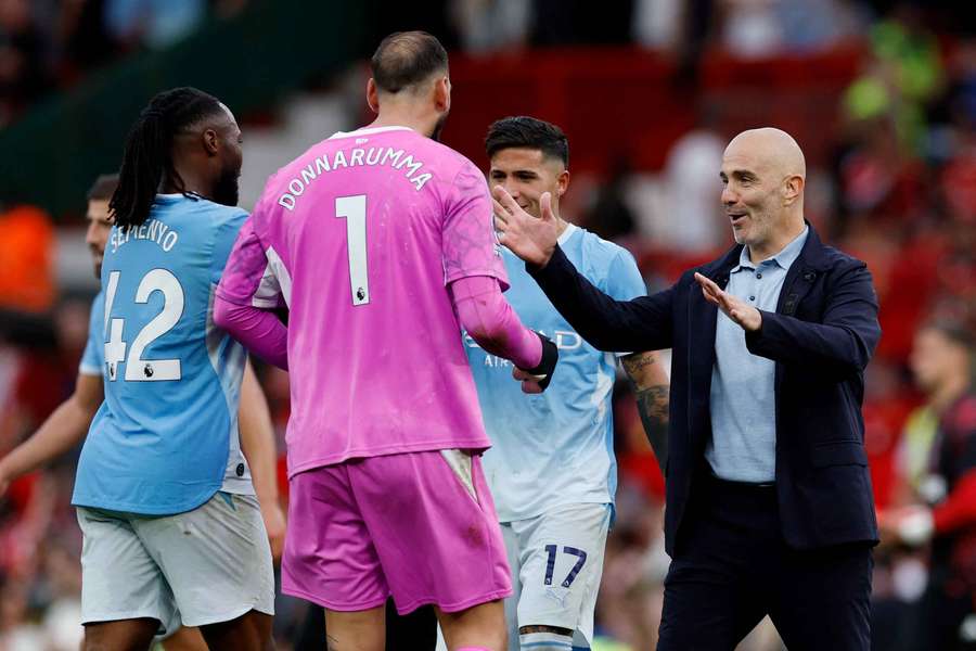 Enzo Maresca celebrates with Gianluigi Donnarumma after beating Liverpool at Anfield