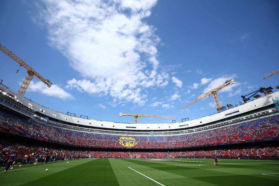 Inside the Camp Nou before the match on Sunday, with the cranes peering down at the checkerboard pitch