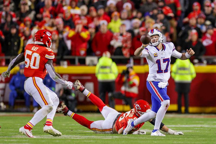 Josh Allen of the Buffalo Bills looks to pass against George Karlaftis of the Kansas City Chiefs
