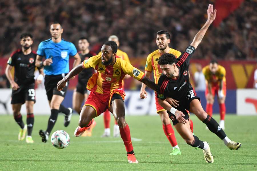 Esperance's Roger Aholou fights for the ball with Ahly's Wessam Abou Ali during the first leg of the CAF Champions League final