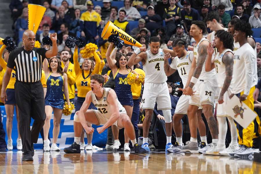 Michigan's bench gets hyped during the NCAA tournament 