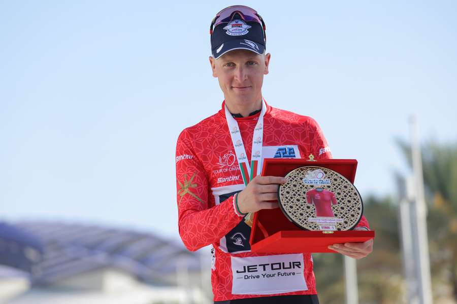 Belgian rider Tim Merlier of Soudal Quick-Step poses in the red jersey