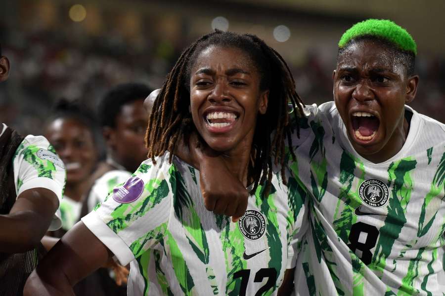 Asisat Oshoala (right) and Onyi Echegini of Nigeria as they celebrate lifting the WAFCON trophy in the 2024 edition