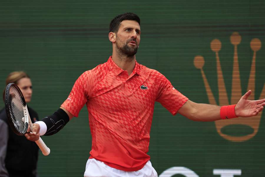 Serbia's Novak Djokovic reacts as he competes against Italy's Lorenzo Musetti