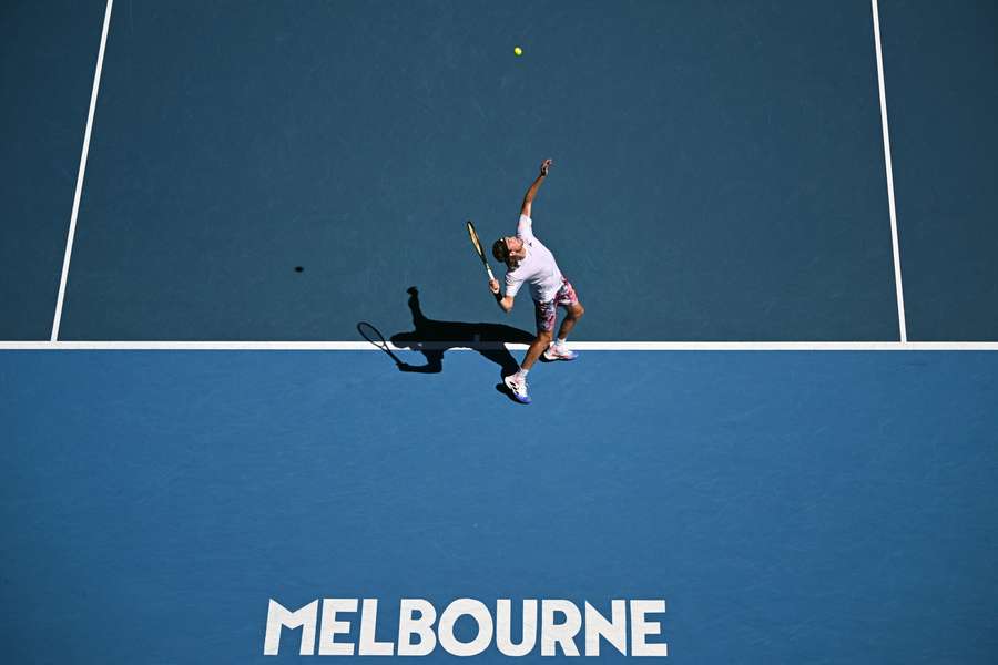 Tsitsipas hits a serve in the semi-finals