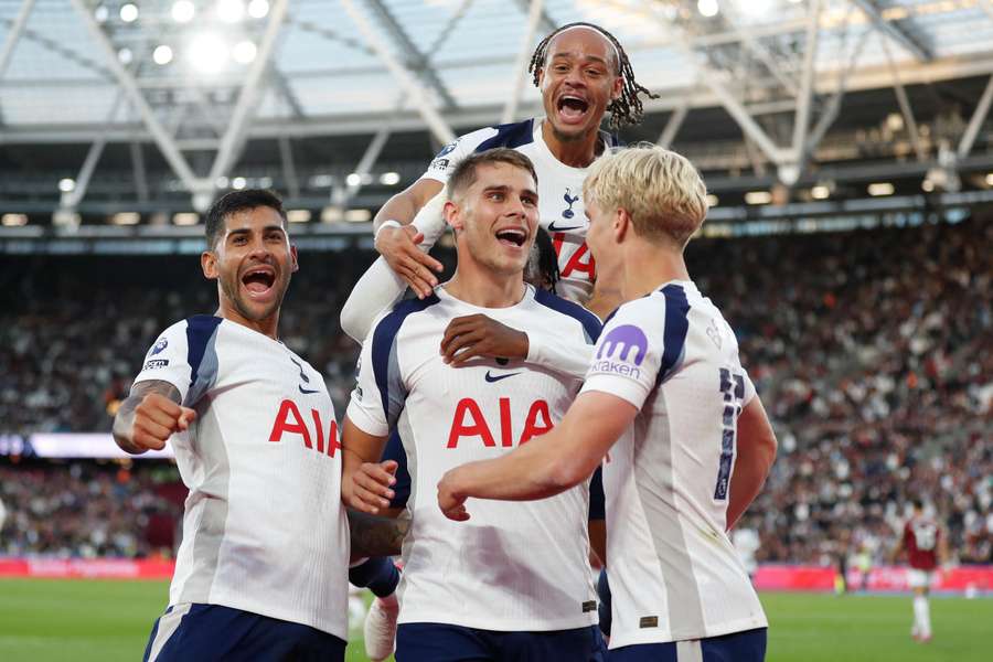 Micky van de Ven celebrates with teammates after scoring Tottenham's third goal