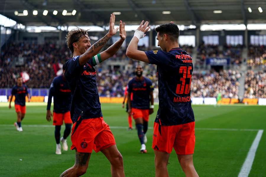 Feyenoord's Mika Marmol (R) celebrates scoring against Cambuur with captain Luciano Valente