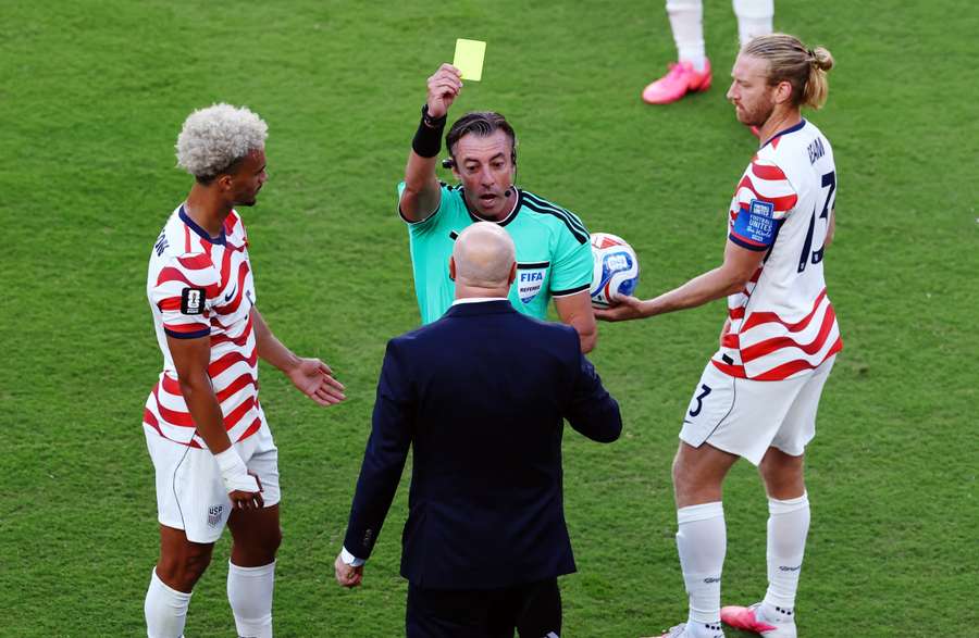Bosnia and Herzegovina coach Sergej Barbarez is shown a yellow card by referee Raphael Claus Bosnia and Herzegovina coach Sergej Barbarez is shown a yellow card by referee Raphael Claus