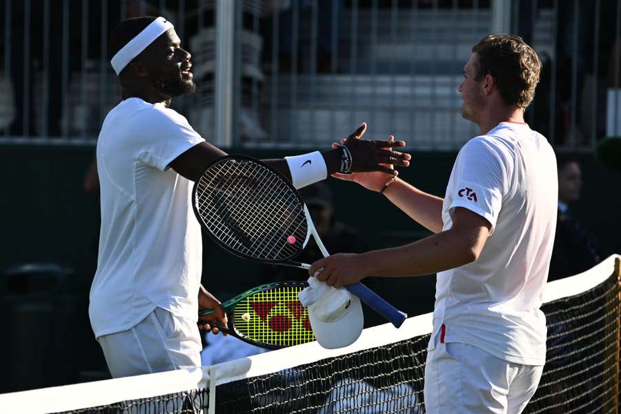 US player Frances Tiafoe shakes hands with Switzerland's Dominic Stricker after winning their men's singles tennis match on the fourth day