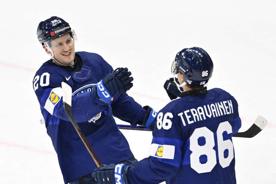 Eeli Tolvanen (left) celebrates completing his hattrick 7-1 with Teuvo Teravainen