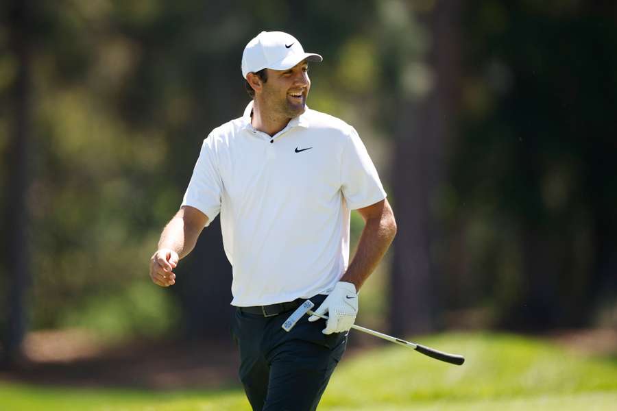 Scottie Scheffler of the United States smiles as he walks to the first green