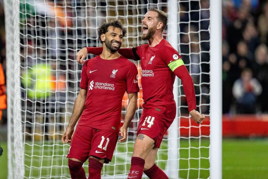 Mohamed Salah celebrates with Jordan Henderson after putting Liverpool 2-0 up from the penalty spot.