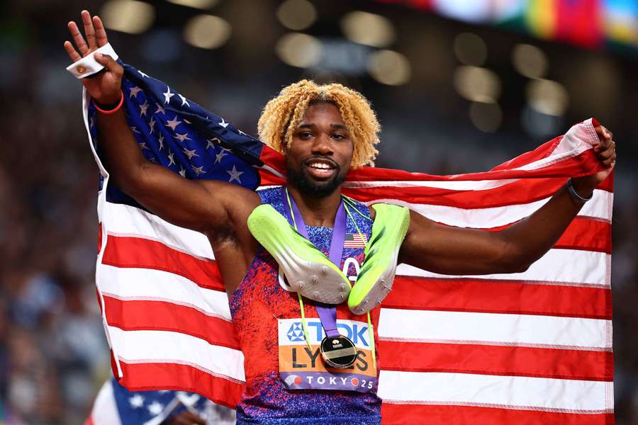 Noah Lyles celebrates after the race