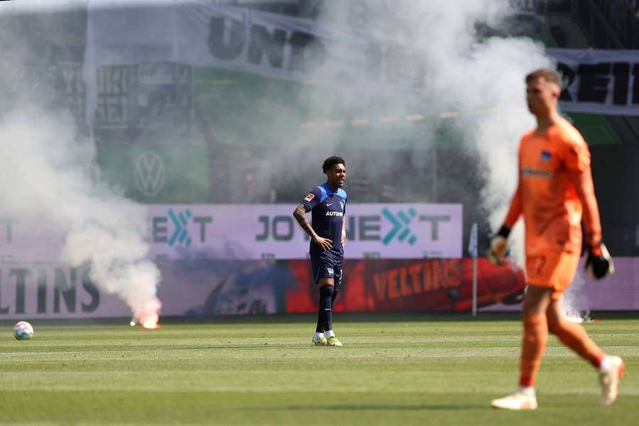 Hertha Berlin's fans throw flares onto the pitch during their final Bundesliga game of the season against Werder Bremen