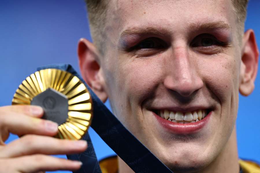 Gold medallist Lukas Maertens of Germany celebrates on the podium after winning the 400m free