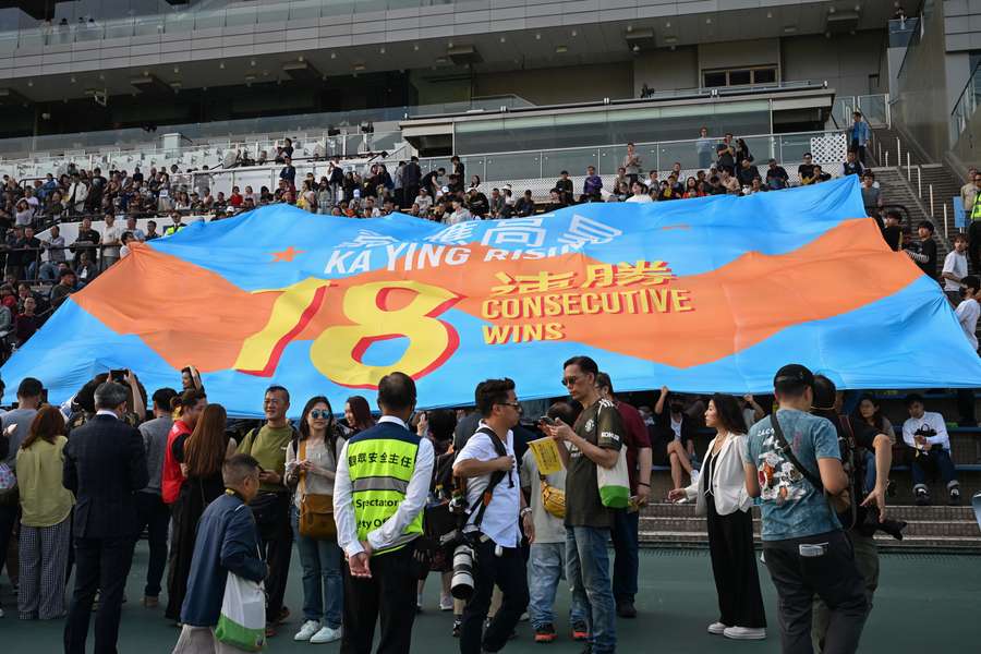 A commemorative flag is unfurled to celebrate Ka Ying Rising's historic win. A commemorative flag is unfurled to celebrate Ka Ying Rising's historic win.
