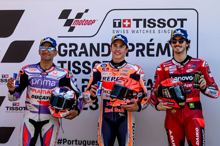 Marc Marquez (C) celebrates his first pole position flanked by second-placed Francesco Bagnaia (R) and third-placed Jorge Martin