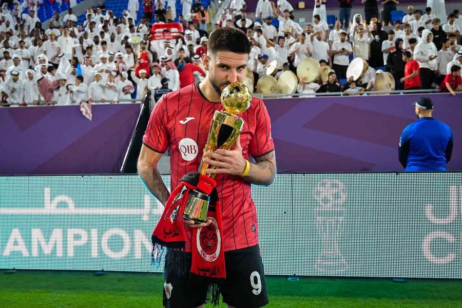 Aleksandar Mitrovic with the QSL Cup