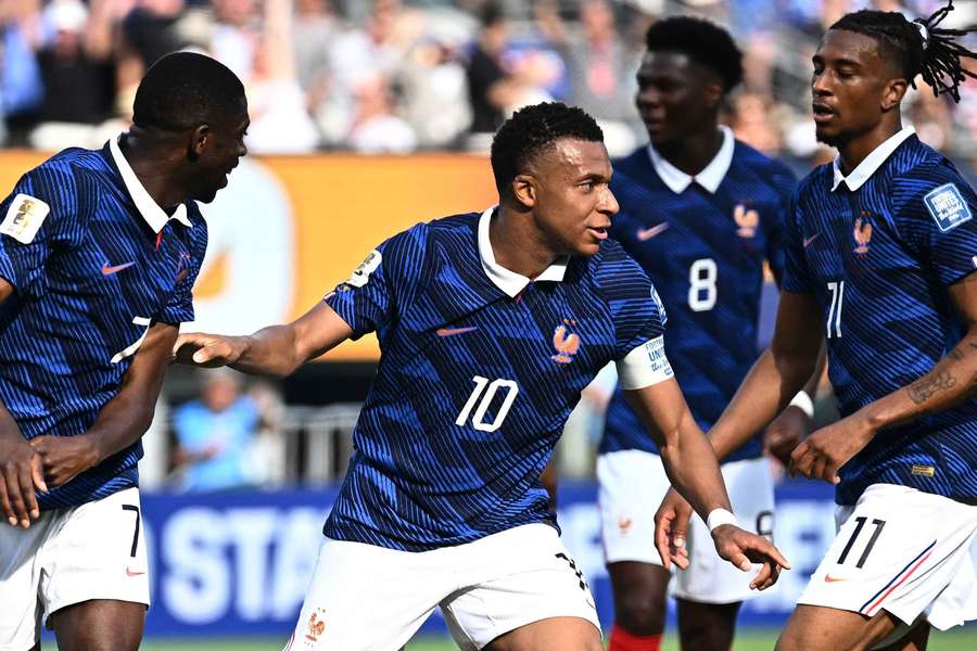 Kylian Mbappe celebrates scoring France's first goal with Ousmane Dembele and Michael Olise