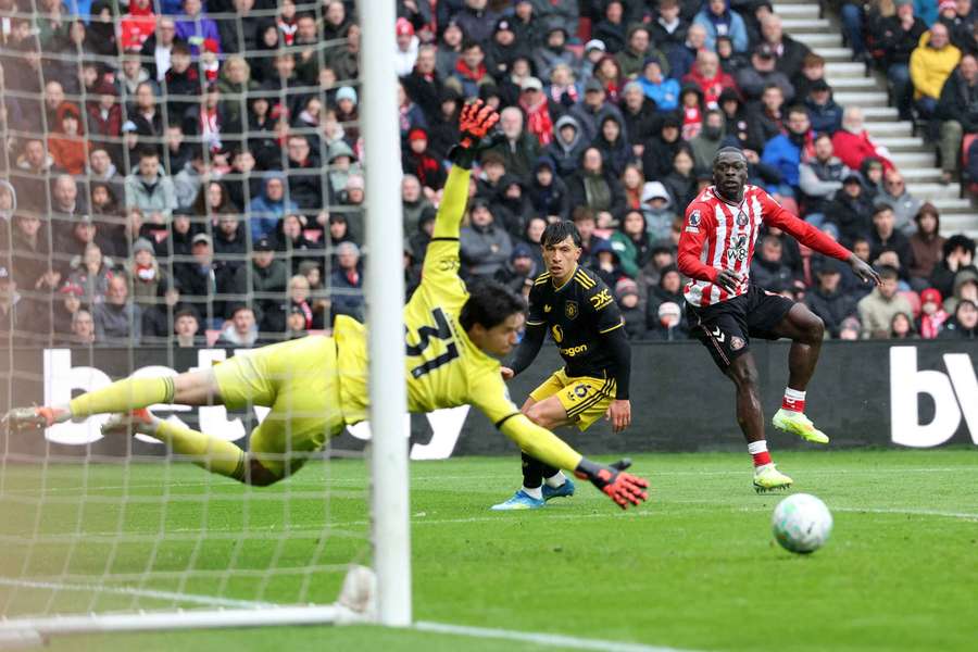 Man Utd goalkeeper Senne Lammens dives to save a shot from Sunderland's Brian Brobbey