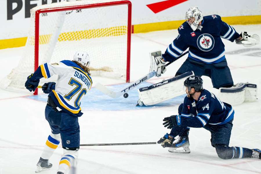 Hellebuyck and his famous save against the Blues