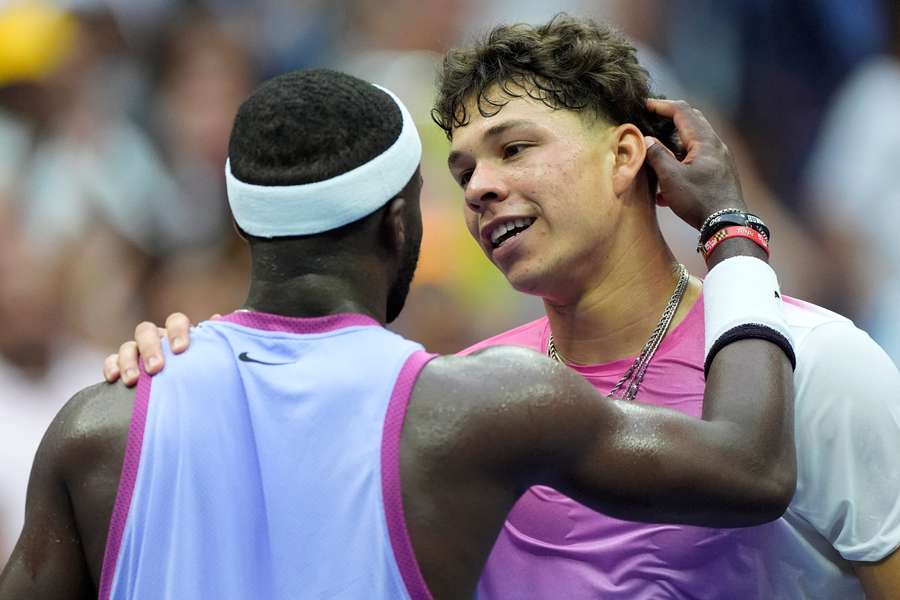 Tiafoe and Shelton embrace at the net