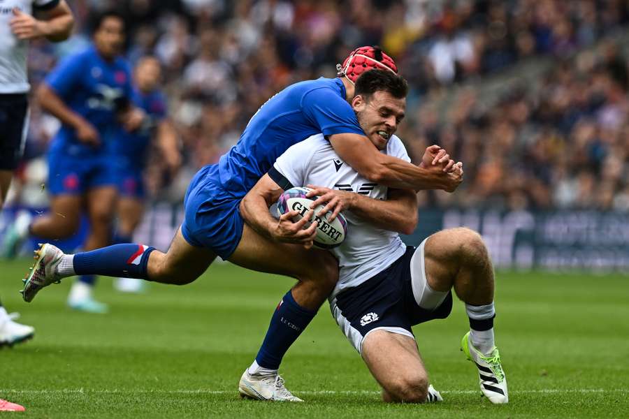 Scotland's Ben White (R) battles for the ball