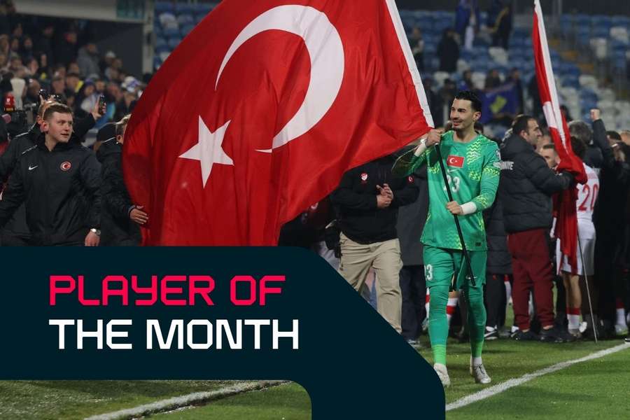 Ugurcan Cakir waves the Turkish flag after his nation qualified for the 2026 FIFA World Cup