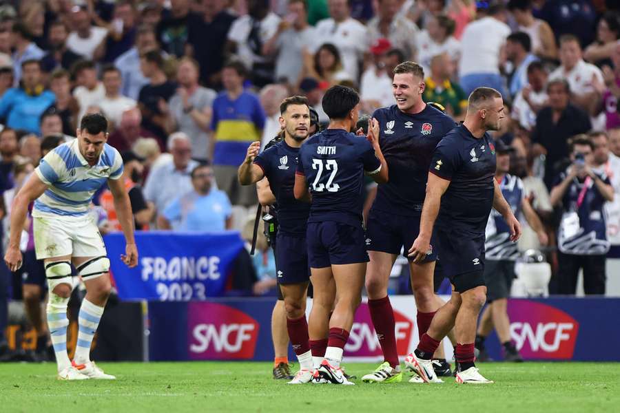 England's players celebrate after beating Argentina