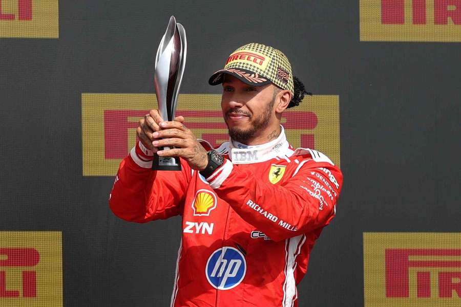 Ferrari's Lewis Hamilton celebrates with his trophy on the podium after finishing third in the British Grand Prix Ferrari's Lewis Hamilton celebrates with his trophy on the podium after finishing third in the British Grand Prix