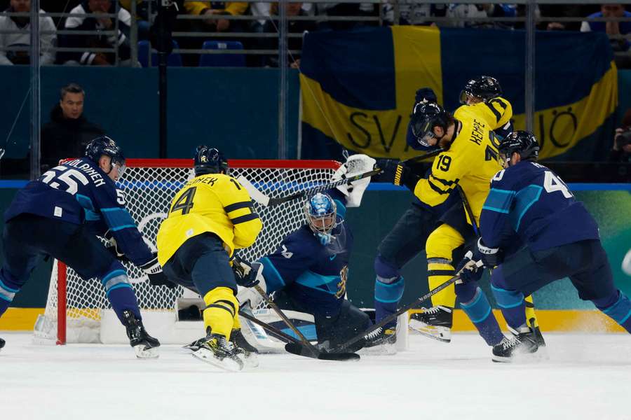 Juuse Saros of Finland saves from Joel Eriksson Ek