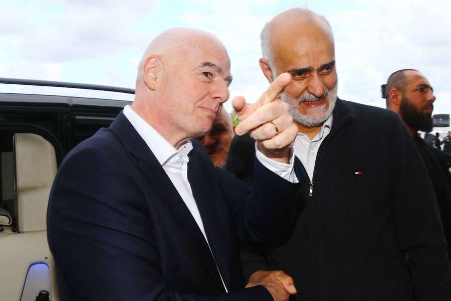 First vice president of the Islamic Republic of Iran Football Federation Mehdi Mohammad Nabi shakes hands with Gianni Infantino