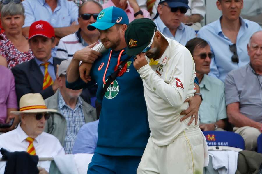 Nathan Lyon was helped off the field after picking up an injury during the second day of the second Test