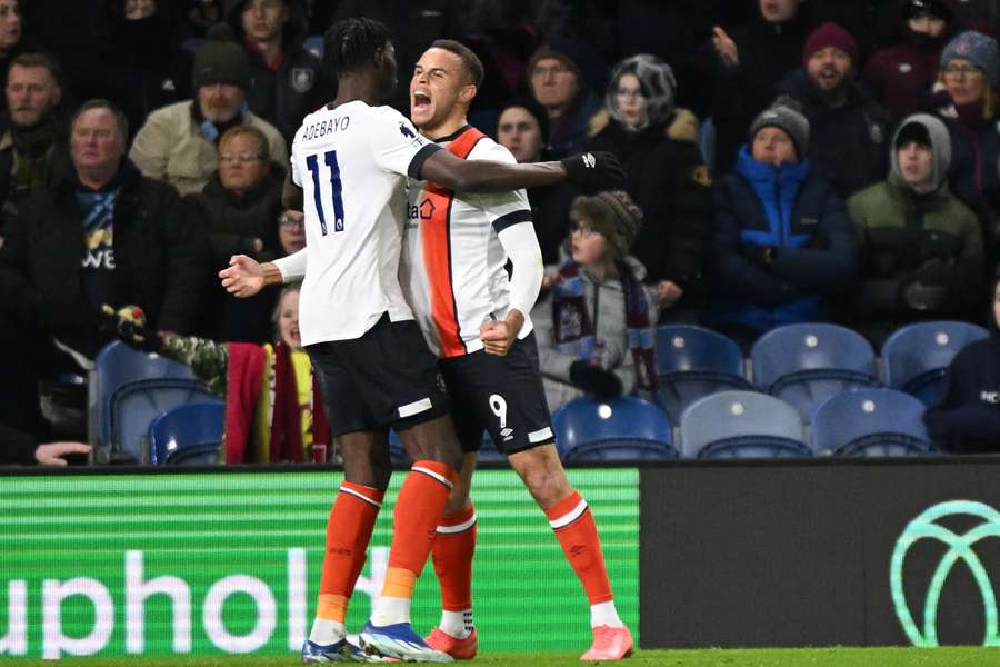 Carlton Morris (R) celebrates with Luton Town's Elijah Adebayo (L) after scoring their late equaliser