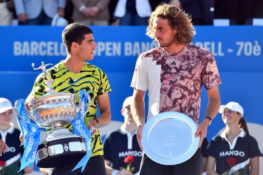 Spain's Carlos Alcaraz and Greece's Stefanos Tsitsipas hold their trophies after the ATP Barcelona Open