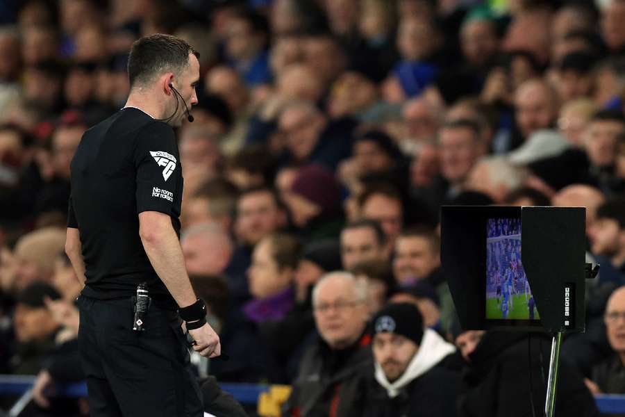 Referee Chris Kavanagh looks at the VAR monitor