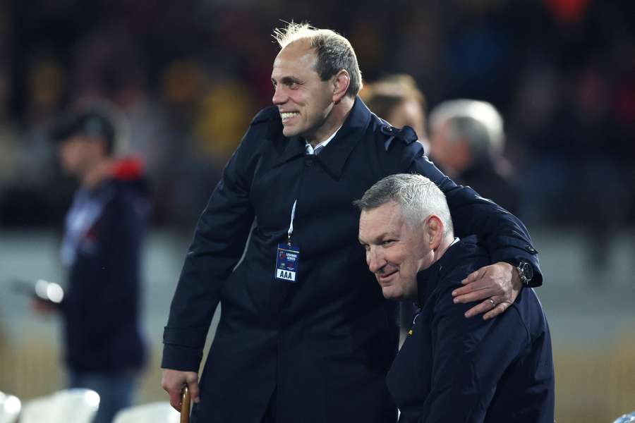 Rugby Australia CEO Phil Waugh hugs former player Justin Harrison at a legends match in Sydney last month.