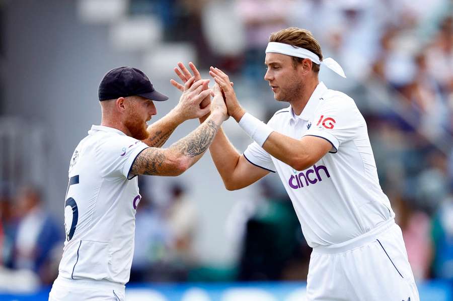 Stuart Broad celebrates with Ben Stokes after taking the wicket of Pat Cummins in the second Test