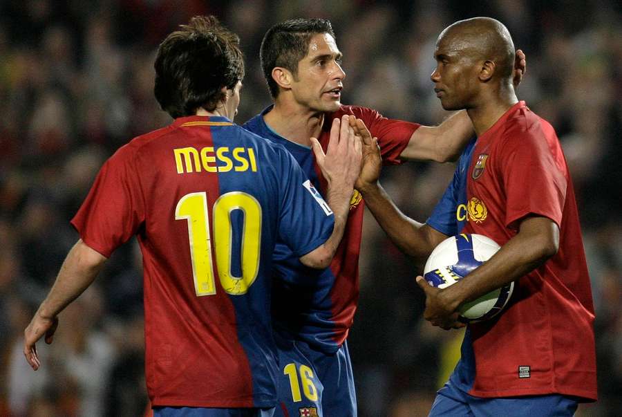 Sylvinho celebrates with Messi and Eto'o. Sylvinho celebrates with Messi and Eto'o.