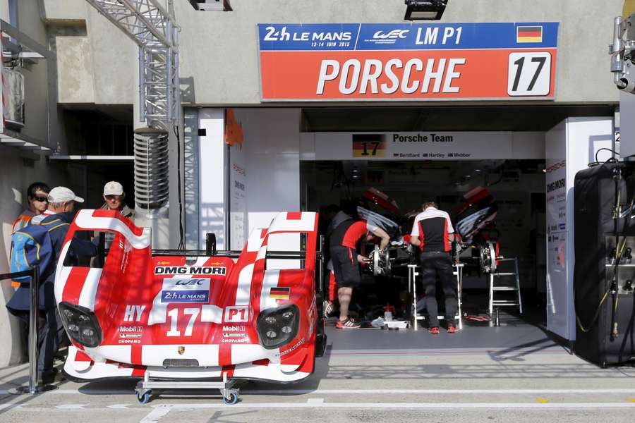 Porsche team mechanics work on the Porsche 919 Hybrid number 17 during the Le Mans 24-hour sportscar race in Le Mans, 2015