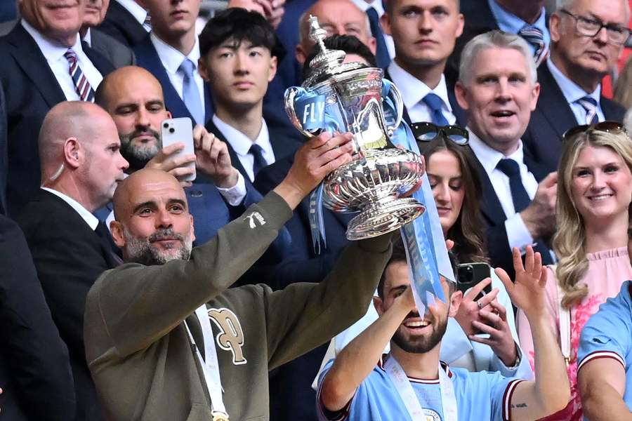 Pep Guardiola, treinador do Manchester City, segura a Taça de Inglaterra depois de a sua equipa ter vencido o Manchester United na final da semana pas