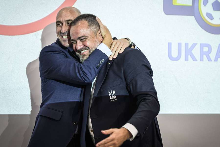 RFEF President Luis Rubiales (L) hugs UAF President Andriy Pavelko following the announcement.