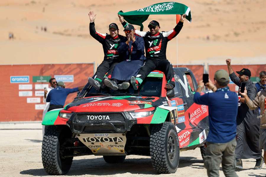 Saudi Arabia's Yazeed Al-Rajhi lifts his nation's flag after triumphing in the Dakar Rally Saudi Arabia's Yazeed Al-Rajhi lifts his nation's flag after triumphing in the Dakar Rally