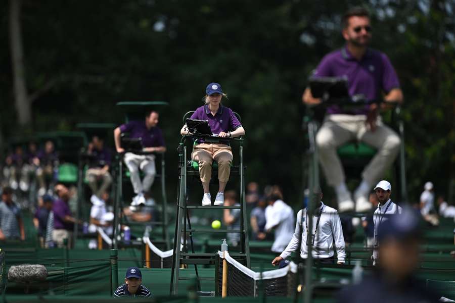 Umpires oversee matches being played on court during the Wimbledon qualifying tennis tournament