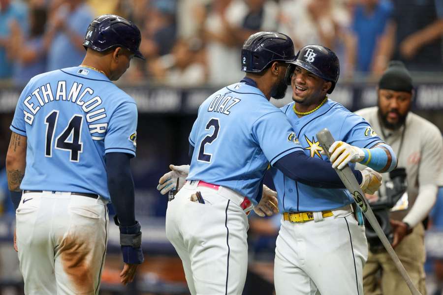 Franco congratulates designated hitter Diaz after hitting a two-run home run against the Braves