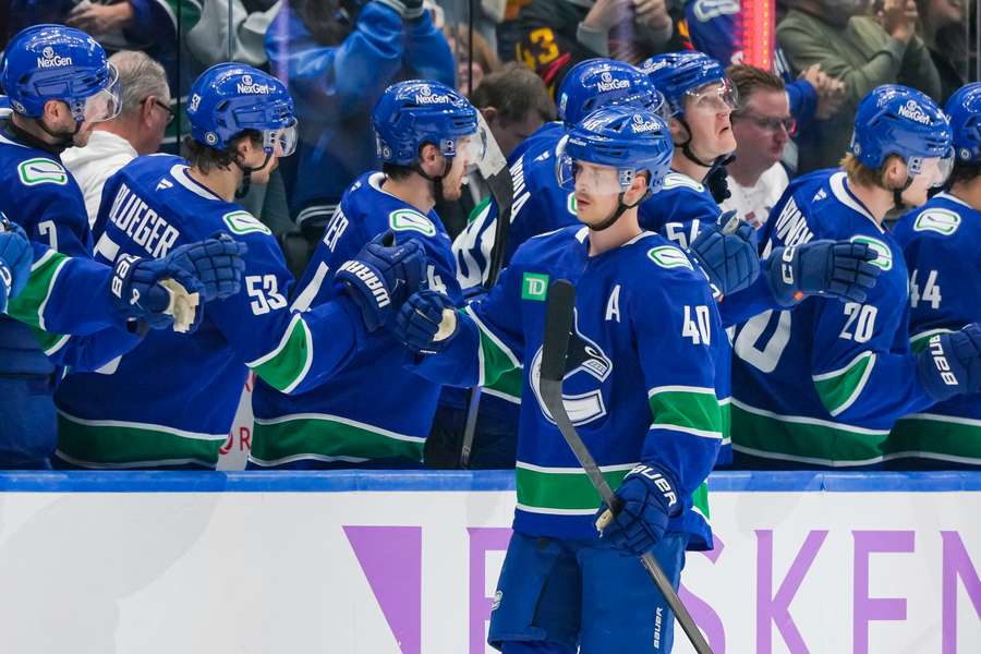 Elias Pettersson of the Vancouver Canucks celebrates with teammates