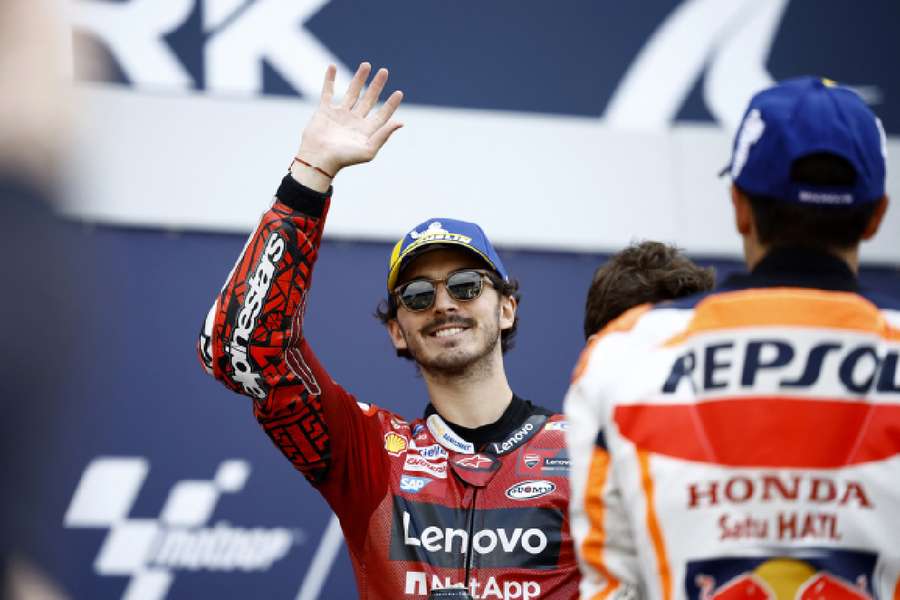 Francesco Bagnaia celebrates after qualifying in pole position