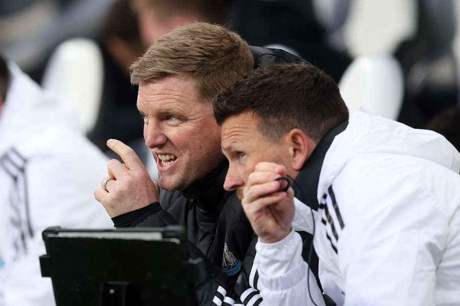 Eddie Howe speaks with one of his assistants during Newcastle's win over Brentford.