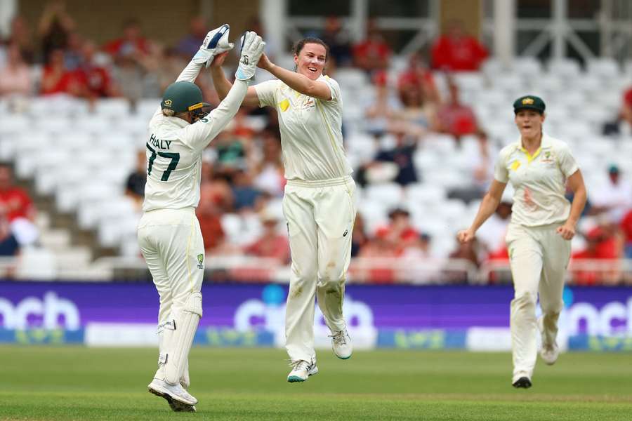 Australia's Tahlia McGrath celebrates with Alyssa Healy after taking the wicket of England's Kate Cross